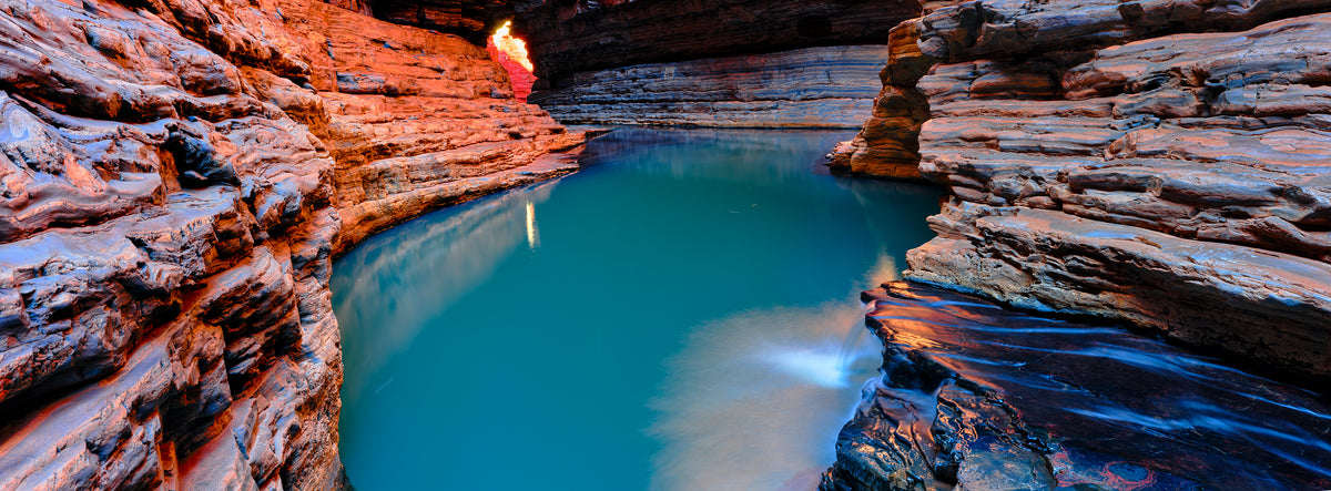Cave with a pool of water and rocky walls, Karijini , western australia 